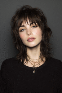 Woman with layered haircut featuring soft textured layers and voluminous hairstyle inspiration